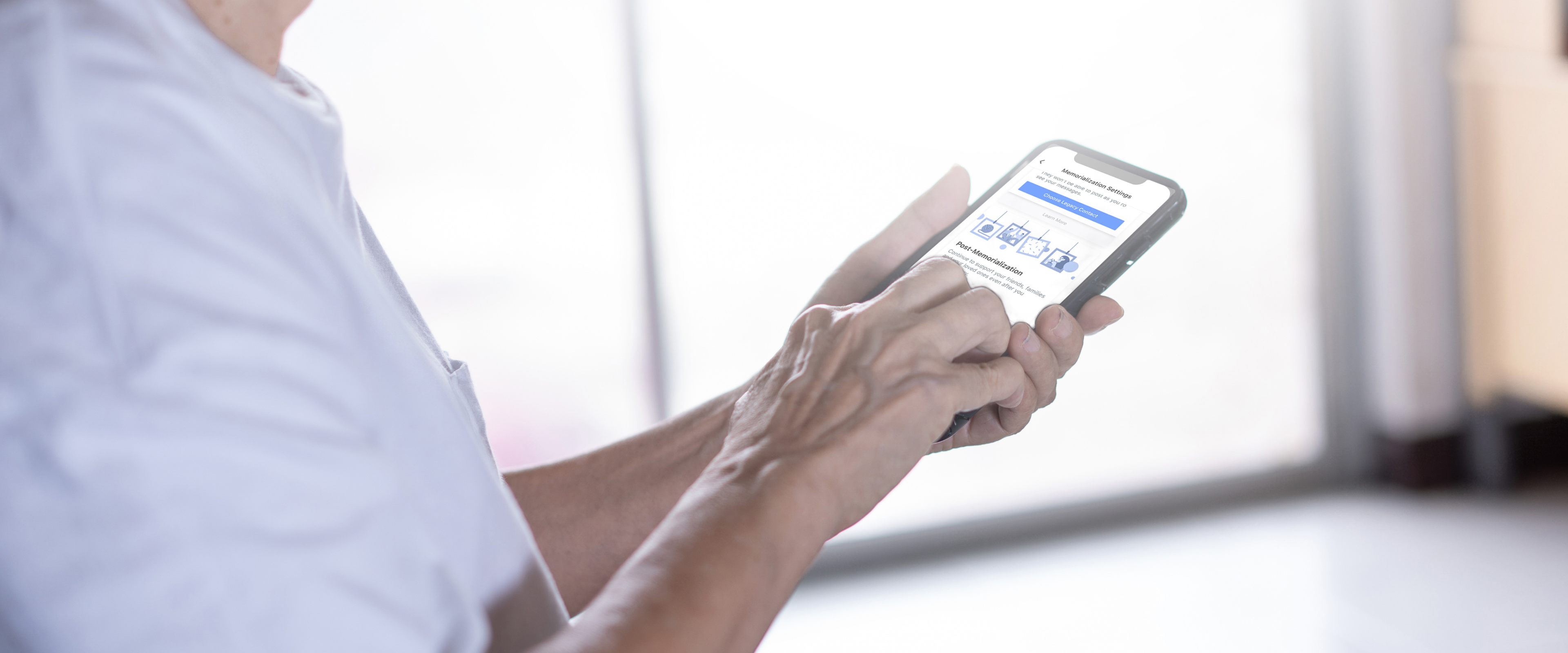 Banner image, Person holding phone showing some mock up image of Facebook Post-memorialization