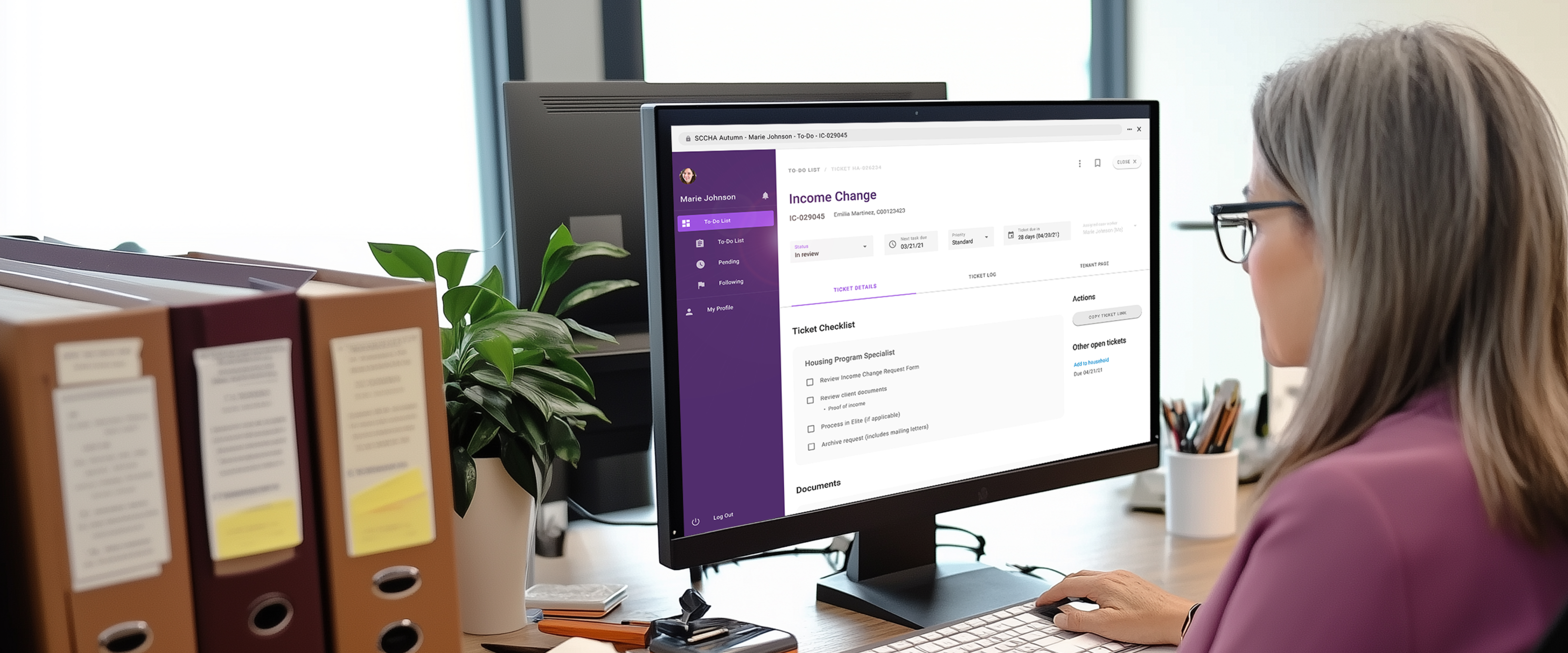 Banner image-A woman working at her desk with a desktop monitor