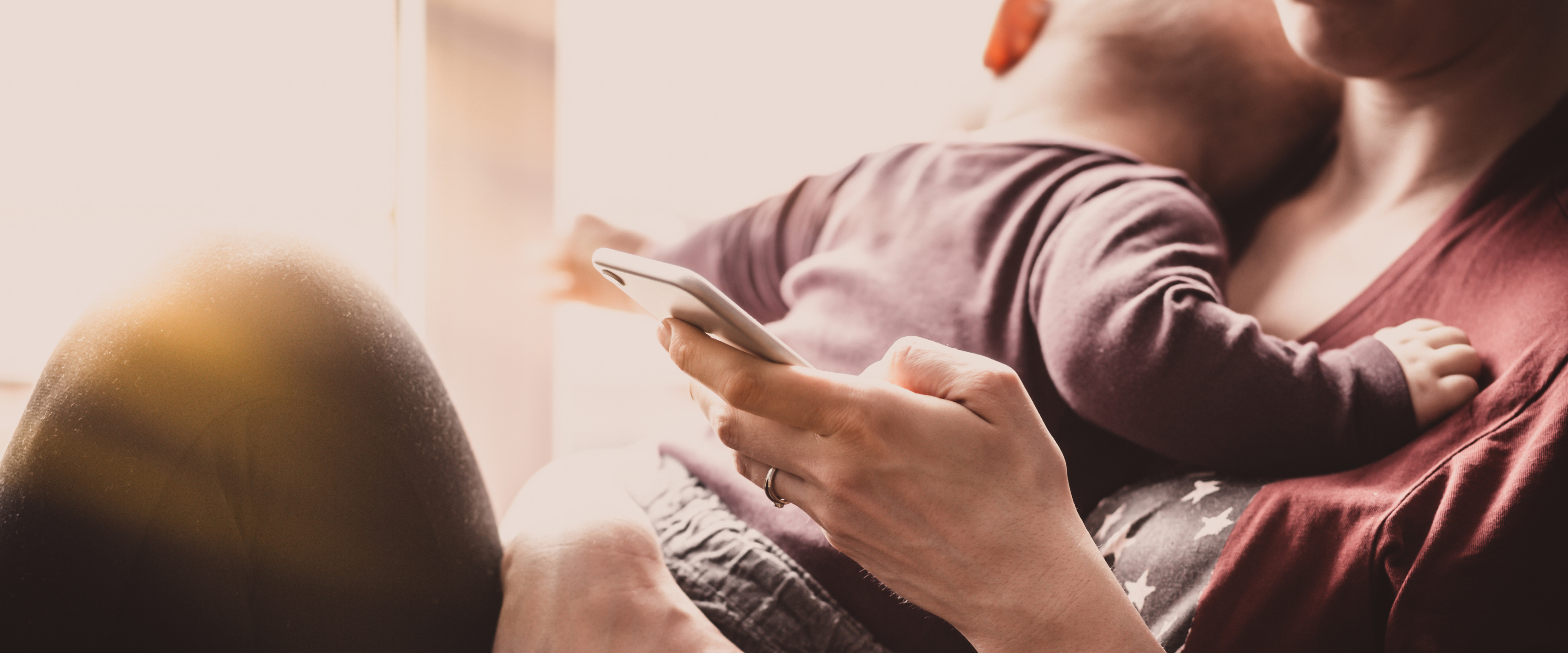 Banner image, person holding phone showing the mockup image of Inclusive Postpartum Care